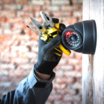 Security camera technician installing a bar security camera